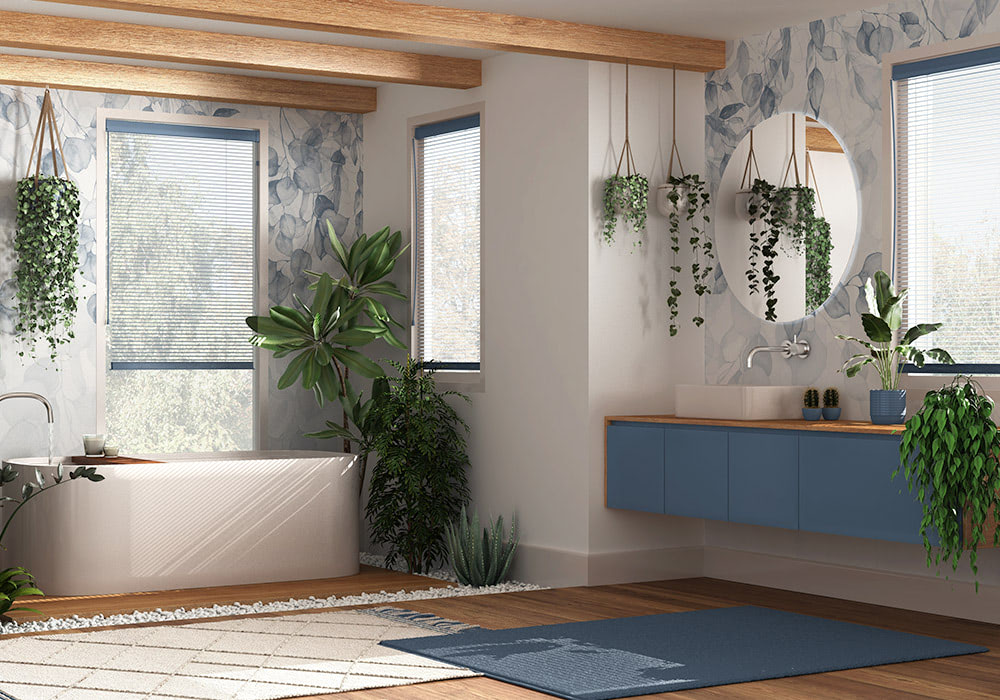 A contemporary bathroom featuring a bathtub and a floating sink under a round mirror, surrounded by hanging plants, wooden beams, and large windows with natural light streaming in.