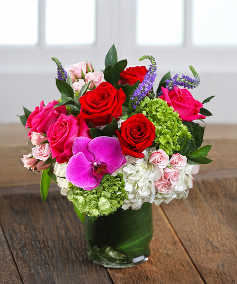 The Love Note Bouquet features hydrangea, roses and orchids in romantic jewel tones