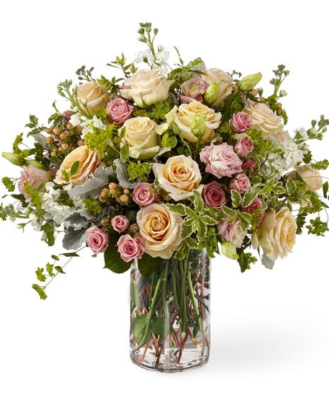 The Pastel Luxury Garden Arrangement features gorgeous mountain roses, white stock and delicate lisianthus and spring accents.