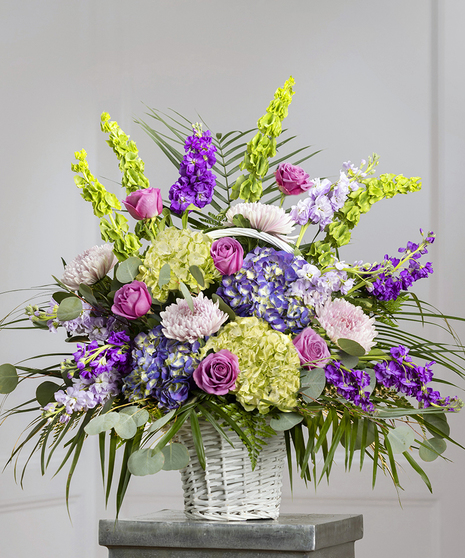 Purple and Lavender Floral Garden Sympathy Basket featuring purple hydrangea, roses, bells of Ireland and seasonal foliage