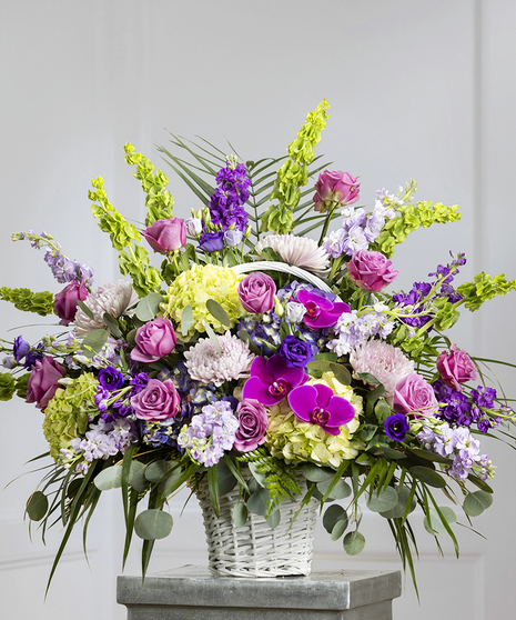 Purple and Lavender Floral Garden Sympathy Basket featuring purple hydrangea, roses, bells of Ireland and seasonal foliage